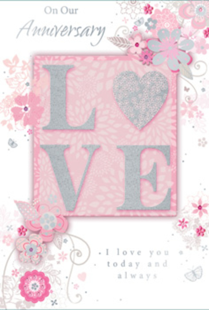 The anniversary card in this image is composed like a gentle love letter, its softly glowing colours and delicate details recalling a carefully arranged bouquet delivered to a Bow doorstep. Dominating the centre is the word LOVE, written in large, confident letters that rise slightly from the card's surface. Each letter is coated with fine, shimmering glitter in a palette of blush pink and frosted silver, giving the impression of light catching on petals in a florist's window near Bow Church. The tactile quality is almost palpable: you can imagine a thumb resting lightly on the word, feeling the subtle grain and raised contours. The background is a muted, powder-pink canvas with hints of pearly white, creating a haze of gentle colour that feels romantic yet understated. Around the focal word, a halo of stylised flowers, leaves, and flowing tendrils curves in an almost circular movement, as though encircling the sentiment with a floral embrace. These illustrations are drawn in fine, graceful lines, with soft shading in pinks, creams, and pale greys, and are accented with touches of silver that glint like tiny ornaments. The blossoms resemble loose, dreamy versions of roses or garden blooms that might feature in a hand-tied anniversary bouquet. Scattered amongst the floral swirls are subtle flourishes and possibly a few tiny butterflies or petals in motion, adding a feeling of gentle movement, as if stirred by a Bow river breeze. An elegant script message, lightly arched or aligned beneath the central motif, expresses warm anniversary wishes with sincerity. Overall, the card radiates tender intimacy and quiet gratitude, echoing the feeling of exchanging heartfelt vows or sharing a simple, candlelit dinner at home after a delivery from a trusted local florist.