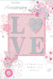 This anniversary card presents a tender, romantic scene, as if it could be propped beside a vase of fresh roses in a Bow kitchen bathed in soft morning light. At the heart of the design, the word LOVE stretches across the card, each letter raised and lavishly dusted with shimmering glitter in shades of blush pink and silvery white. The slight embossing gives the text real presence and suggests a pleasingly tactile feel under the fingertips. The background gently melts from a pale, powdery pink to a deeper blush, creating the sense of a glowing sky at dusk over the rooftops of E3. Surrounding the central word, delicate, hand-drawn flowers and swaying leaves arc in graceful patterns, their lines so fine they resemble a florist's pencil sketch capturing the curve of stems in a romantic arrangement. The blossoms are soft and stylised, tinted in blush, ivory, and gentle grey, with subtle silver highlights that twinkle quietly like fairy lights on a Bow balcony. Small flourishes, such as curling tendrils, petals in mid-fall, or barely visible butterfly shapes, add an airy sense of movement, as though a breeze is lifting the design. An elegant script font carries a heartfelt anniversary message, likely including expressions of thanks, devotion, and the joy of shared memories. The writing weaves harmoniously among the decorative elements without overpowering the image. Altogether, the card feels like a paper echo of a hand-tied anniversary bouquet: refined, softly fragrant in the imagination, and perfectly suited to celebrate the steady, enduring love of a couple enjoying life together along the quiet streets and green pockets of Bow.